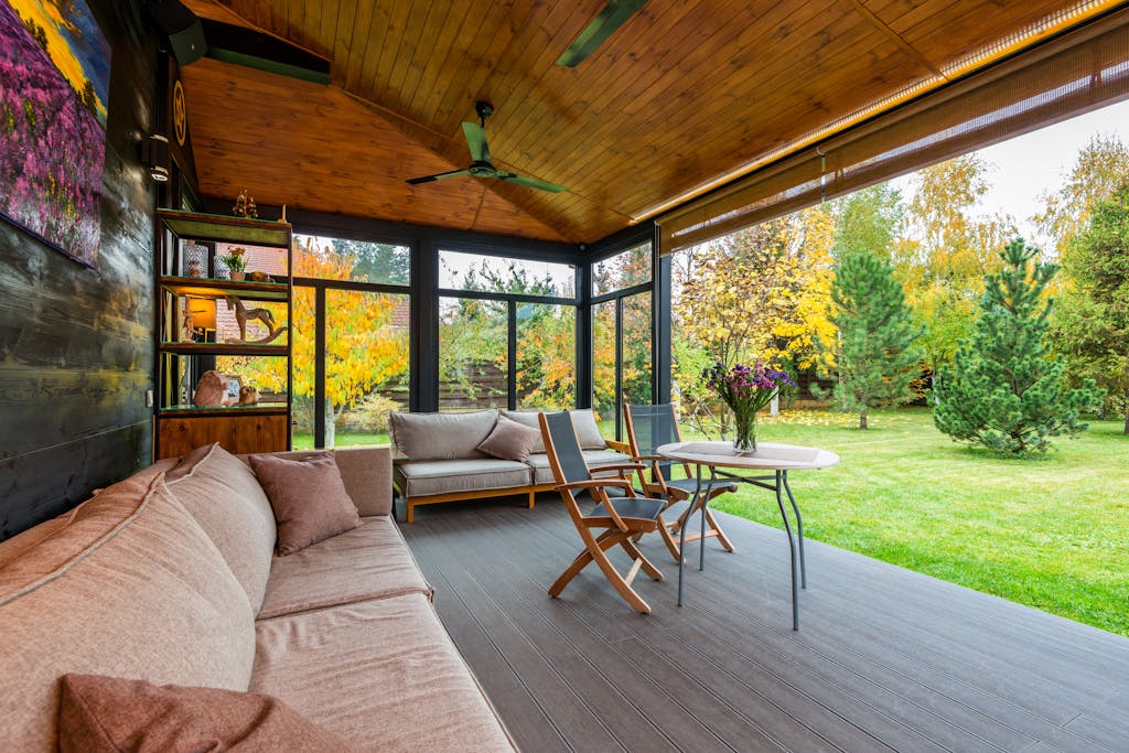 Elegant modern porch with comfortable seating and vibrant garden view.