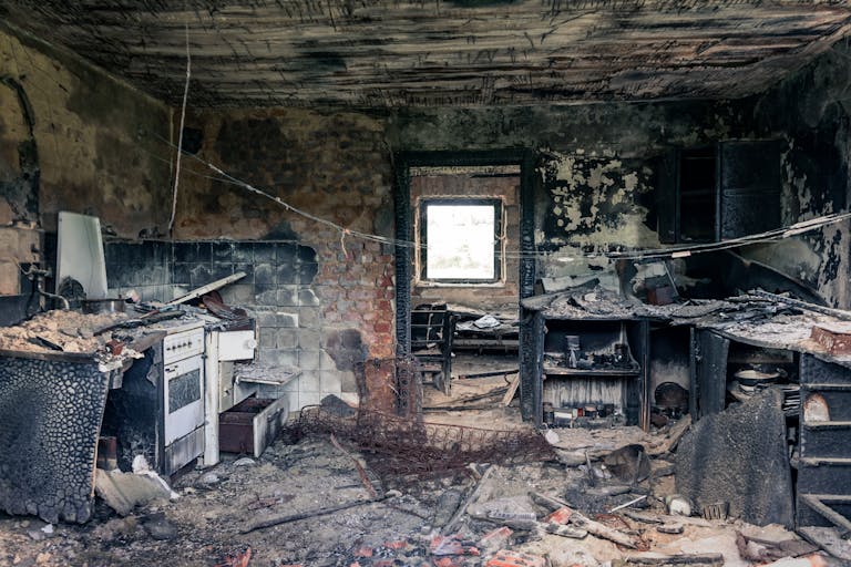 Explore an abandoned, fire-damaged kitchen illustrating decay and destruction.