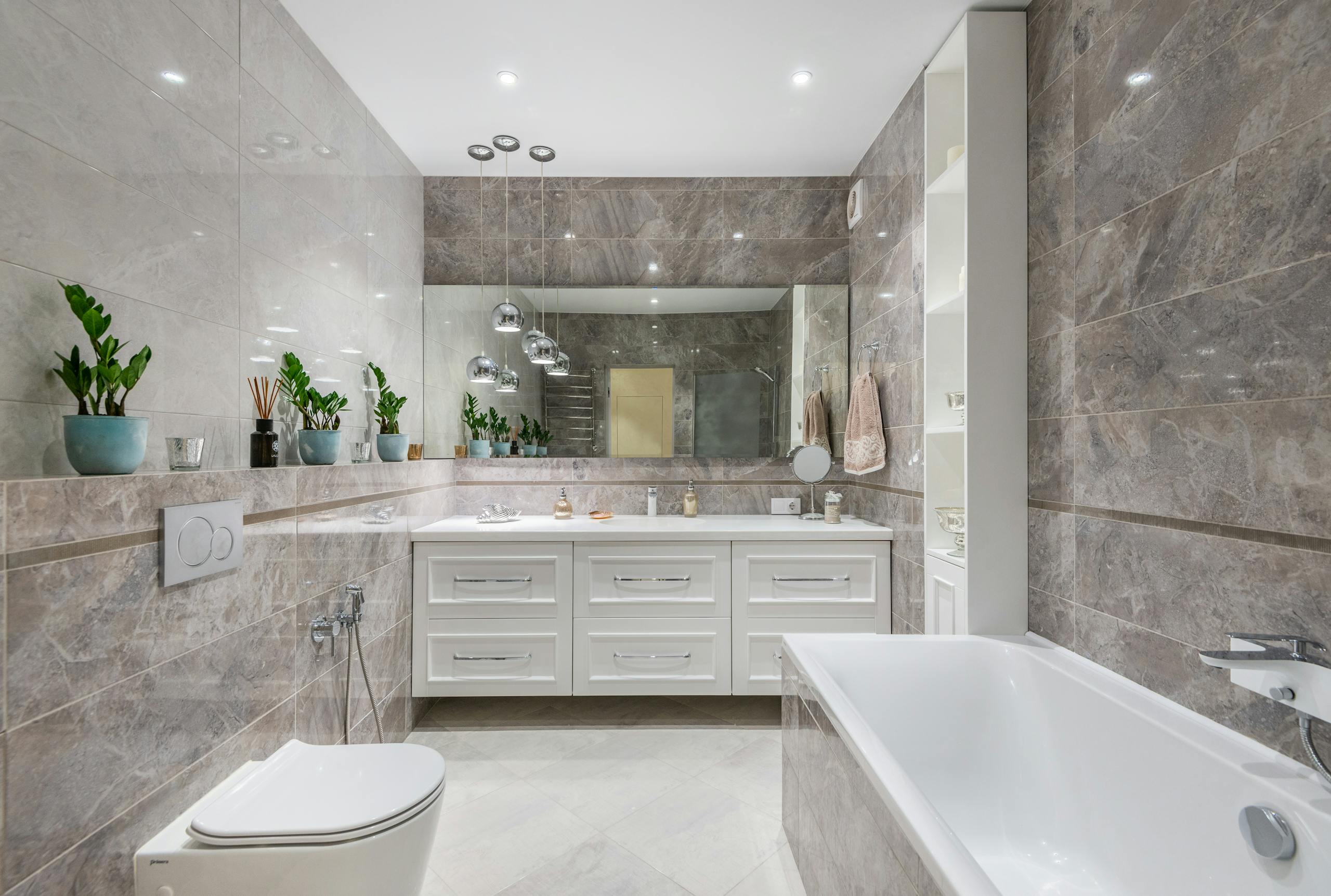 Spacious marble bathroom with sleek fixtures and elegant decor, ideal for luxury home interiors.